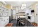 Elegant kitchen featuring white cabinets, a marble island, and stainless steel appliances at 750 N Clarkson St, Denver, CO 80218