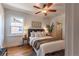 Inviting bedroom with a ceiling fan, large window, and comfortable bed with decorative pillows at 1836 S Grant St, Denver, CO 80210