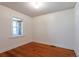 Bright bedroom with hardwood floors, white trim and a window offering natural light at 1836 S Grant St, Denver, CO 80210