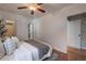Comfortable bedroom with hardwood floors, ceiling fan, and decorative accents at 1836 S Grant St, Denver, CO 80210