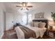Cozy bedroom featuring a ceiling fan, a bed with stylish pillows, and natural light at 1836 S Grant St, Denver, CO 80210
