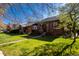 Beautiful home with a well-maintained lawn, mature trees and vibrant landscaping at 1836 S Grant St, Denver, CO 80210