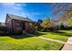 Inviting home with a lush green lawn, mature trees, and a charming brick facade at 1836 S Grant St, Denver, CO 80210