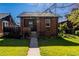 Charming brick home with a well-kept lawn, mature landscaping, and inviting curb appeal at 1836 S Grant St, Denver, CO 80210