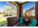 Charming brick front porch with vintage blue seating offering an inviting outdoor space to relax at 1836 S Grant St, Denver, CO 80210