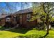Charming brick home with a well-manicured front lawn and mature landscaping at 1836 S Grant St, Denver, CO 80210