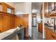 Hallway with stained wood wall leads to the kitchen with stainless steel appliances at 1836 S Grant St, Denver, CO 80210