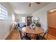 Charming living room showcasing a round wooden table and cozy seating area with ample natural light at 1836 S Grant St, Denver, CO 80210