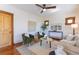 An airy living room with a ceiling fan, two arm chairs, and a cream colored couch at 1836 S Grant St, Denver, CO 80210