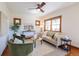 Bright living room features a ceiling fan, two arm chairs, and a cream colored couch at 1836 S Grant St, Denver, CO 80210