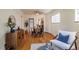 Open-concept living and dining area with hardwood floors, ceiling fan, and modern furnishings at 1836 S Grant St, Denver, CO 80210