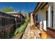 Charming walkway alongside the house with lush landscaping, enhancing curb appeal at 1836 S Grant St, Denver, CO 80210