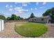 View of the backyard showing a partially-shaded grassy area, gravel area, and wood fence at 13225 Grove Way, Broomfield, CO 80020