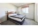 Bright bedroom with carpet, a window, and a wooden headboard bed at 13225 Grove Way, Broomfield, CO 80020
