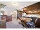 Inviting dining area with a wooden table, cabinet, and partial view into the kitchen space at 13225 Grove Way, Broomfield, CO 80020