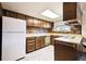 Functional kitchen with ample cabinet space, white appliances, and a brick backsplash at 13225 Grove Way, Broomfield, CO 80020