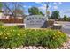 Entrance to Westlake Village in Broomfield featuring lush flowers, stone accents, and mature trees at 13225 Grove Way, Broomfield, CO 80020