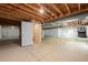 Unfinished basement with open ceiling, concrete flooring, and ample room for activities at 15414 Xenia Ct, Thornton, CO 80602