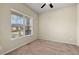 Cozy bedroom featuring neutral walls, plush carpeting, and a large window offering natural light at 15414 Xenia Ct, Thornton, CO 80602