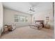 Spacious bedroom with a large window, a ceiling fan, and carpeted floors, creating a relaxing space at 15414 Xenia Ct, Thornton, CO 80602