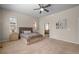 Bright bedroom with a large window, a ceiling fan, and carpeted floors, creating a relaxing space at 15414 Xenia Ct, Thornton, CO 80602