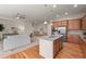 Open-concept kitchen with an island and stainless steel appliances, seamlessly connecting to the living space at 15414 Xenia Ct, Thornton, CO 80602