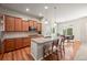 Well-equipped kitchen featuring a granite island, stainless steel appliances, and a seamless connection to the dining area at 15414 Xenia Ct, Thornton, CO 80602