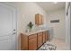 Laundry room with upper and lower cabinets, counter, and a washing machine at 15414 Xenia Ct, Thornton, CO 80602