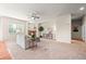 Bright living room with a cozy fireplace, ceiling fan, and neutral tones at 15414 Xenia Ct, Thornton, CO 80602
