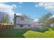 Spacious backyard featuring a large lawn, patio, and privacy fence, perfect for outdoor entertaining and relaxation at 4933 S Xenon Ct, Morrison, CO 80465