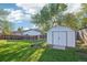 Backyard with a wooden fence, large green space, and a shed for storage at 4933 S Xenon Ct, Morrison, CO 80465