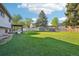 Large, fenced backyard with well-maintained lawn, patio area, and ample room for gardening and play at 4933 S Xenon Ct, Morrison, CO 80465