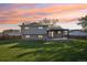Charming backyard with covered patio, lush lawn, and fenced perimeter, ideal for outdoor gatherings at 4933 S Xenon Ct, Morrison, CO 80465
