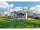 Spacious backyard with a wooden fence, large green space, and backyard patio at 4933 S Xenon Ct, Morrison, CO 80465