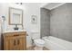 Updated bathroom with gray tiled shower and wooden vanity at 4933 S Xenon Ct, Morrison, CO 80465