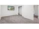 Bedroom featuring gray carpet, a black window, and an open closet space at 4933 S Xenon Ct, Morrison, CO 80465
