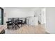 Upstairs dining area with modern black table and chairs, black iron railing, stairs and an airy, open design at 4933 S Xenon Ct, Morrison, CO 80465