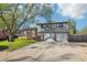 Charming two-story home with a lush front yard and a two-car garage on a sunny day at 4933 S Xenon Ct, Morrison, CO 80465