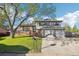 Charming two-story home with a lush front yard and a two-car garage on a sunny day at 4933 S Xenon Ct, Morrison, CO 80465