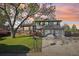 Charming two-story home with a lush front yard and a two-car garage at sunset at 4933 S Xenon Ct, Morrison, CO 80465