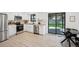 Well-lit kitchen features stainless steel appliances, white cabinetry and a black-framed sliding door to outdoor area at 4933 S Xenon Ct, Morrison, CO 80465