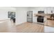 Open concept kitchen featuring stainless steel appliances, white cabinetry and butcher block countertop adjacent to dining area at 4933 S Xenon Ct, Morrison, CO 80465