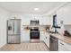 Bright modern kitchen featuring stainless steel appliances, stylish white cabinets and butcher block countertop at 4933 S Xenon Ct, Morrison, CO 80465