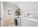 Bright laundry room with washer, dryer, storage and room for folding clothes at 4933 S Xenon Ct, Morrison, CO 80465
