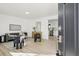 Inviting living room with an open doorway to the kitchen featuring modern decor and hardwood floors at 4933 S Xenon Ct, Morrison, CO 80465