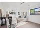 Bright living room with modern gray furniture, area rug, and views to the outside patio at 4933 S Xenon Ct, Morrison, CO 80465