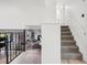 Open concept living room with fireplace and staircase to second floor featuring wrought iron railing at 4933 S Xenon Ct, Morrison, CO 80465