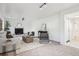 Living room boasts a fireplace, gray seating, light-colored couch and carpet at 4933 S Xenon Ct, Morrison, CO 80465