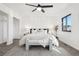 Stylish bedroom with a decorative accent wall and a ceiling fan at 4933 S Xenon Ct, Morrison, CO 80465