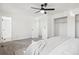 A bright bedroom features carpet, ceiling fan, and a doorway leading to another room at 4933 S Xenon Ct, Morrison, CO 80465